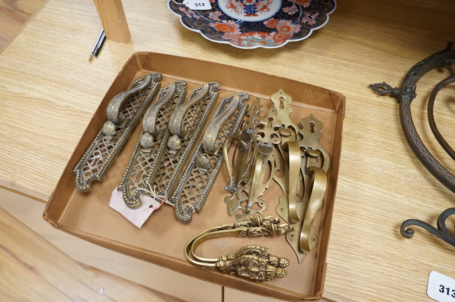 A collection of 19th century cast brass tie backs, largest 26cm high